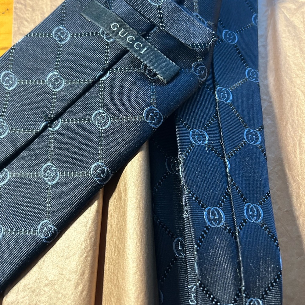Pair of authentic Gucci and Burberry classic design neckties.